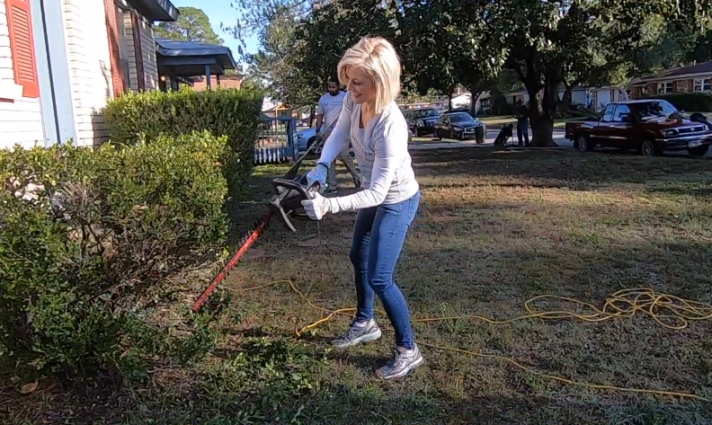 Woman trimming bushes